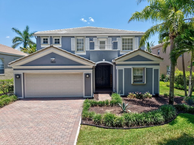 9800 Stover Way, Wellington, FL 33414 - view of front of house featuring decorative driveway, a tile roof, and stucco siding