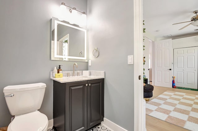 9800 Stover Way, Wellington, FL 33414 - bathroom with vanity, a ceiling fan, toilet, baseboards, and wood finished floors