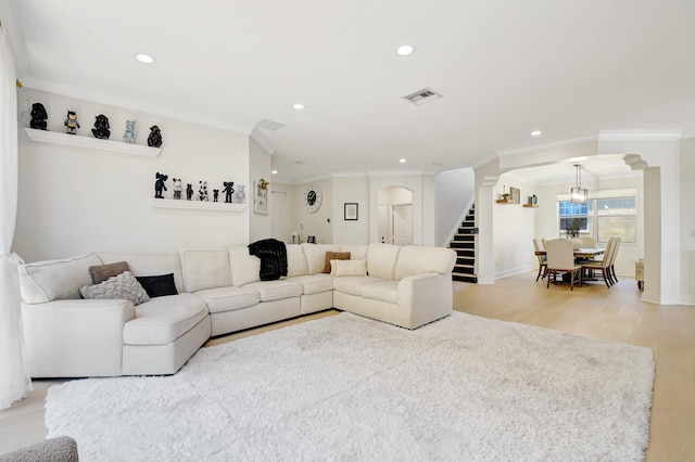 9800 Stover Way, Wellington, FL 33414 - living area featuring arched walkways, recessed lighting, light wood-type flooring, stairway, and crown molding
