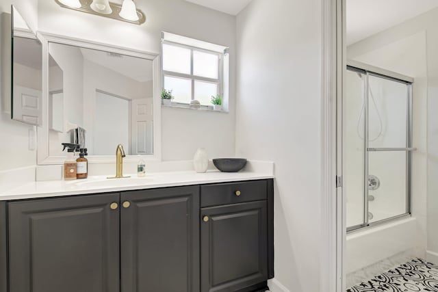 9800 Stover Way, Wellington, FL 33414 - bathroom featuring vanity, shower / bath combination with glass door, baseboards, and tile patterned flooring