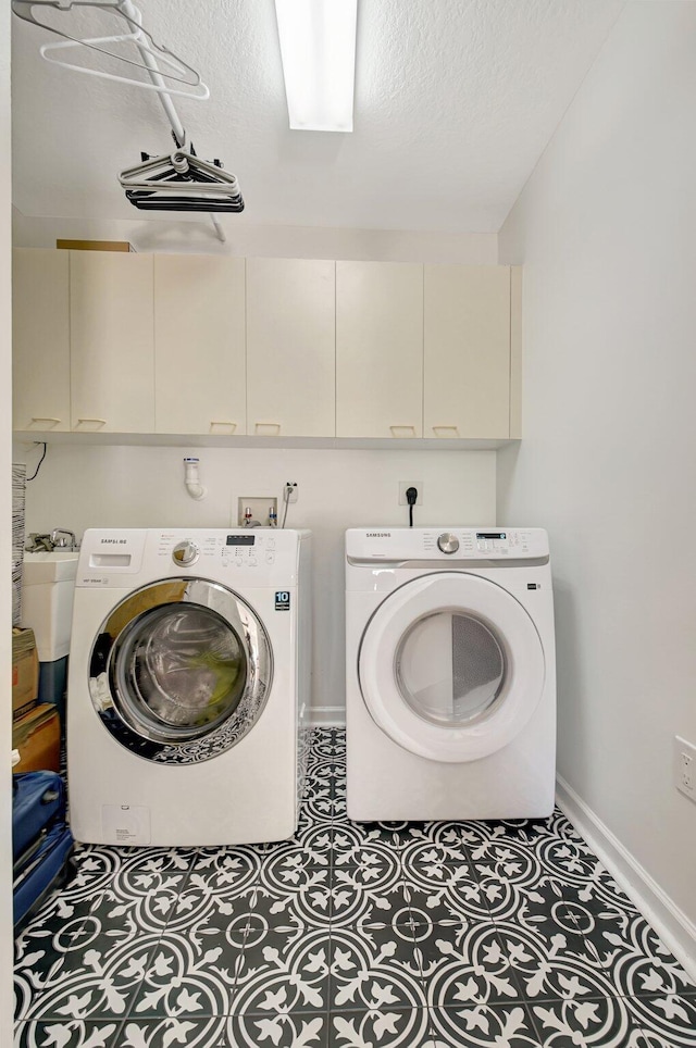 9800 Stover Way, Wellington, FL 33414 - washroom featuring cabinet space, washing machine and clothes dryer, baseboards, and a textured ceiling