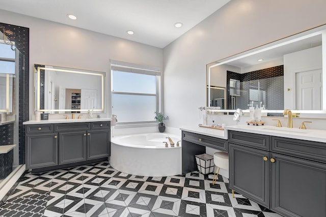 9800 Stover Way, Wellington, FL 33414 - bathroom with two vanities, a stall shower, healthy amount of natural light, a bath, and recessed lighting