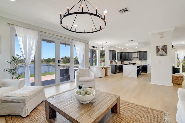 9800 Stover Way, Wellington, FL 33414 - living room featuring a chandelier, french doors, a water view, recessed lighting, and crown molding