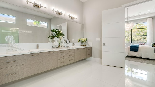 13206 Faberge Pl, Palm Beach Gardens, FL 33418 - full bath featuring double vanity, tile patterned floors, and a chandelier
