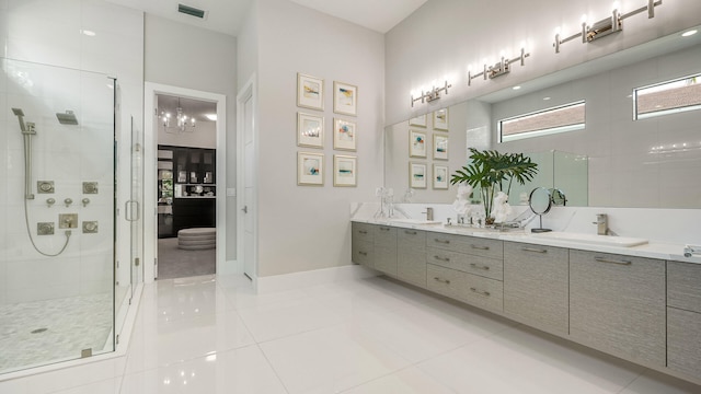 13206 Faberge Pl, Palm Beach Gardens, FL 33418 - full bathroom with a stall shower, double vanity, tile patterned floors, and baseboards