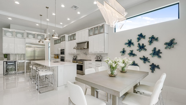 13206 Faberge Pl, Palm Beach Gardens, FL 33418 - kitchen featuring under cabinet range hood, wine cooler, high end appliances, backsplash, and a sink