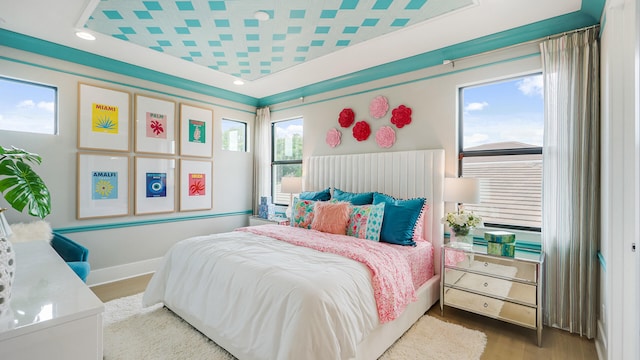13206 Faberge Pl, Palm Beach Gardens, FL 33418 - bedroom with wood finished floors, a raised ceiling, baseboards, and recessed lighting