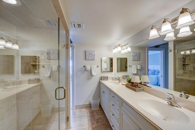 2641 NE Ocean Blvd Unit 106, Stuart, FL 34996 - full bathroom featuring double vanity, a shower stall, baseboards, and tile patterned flooring
