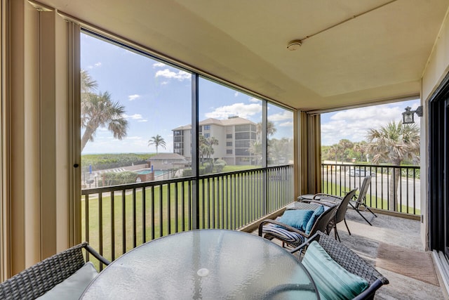 2641 NE Ocean Blvd Unit 106, Stuart, FL 34996 - sunroom with outdoor dining space and carpet