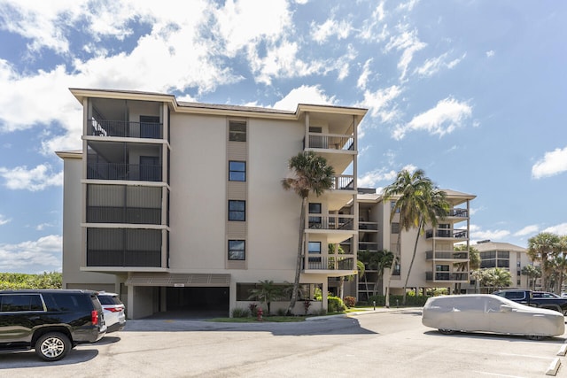 2641 NE Ocean Blvd Unit 106, Stuart, FL 34996 - view of apartment building / complex featuring uncovered parking