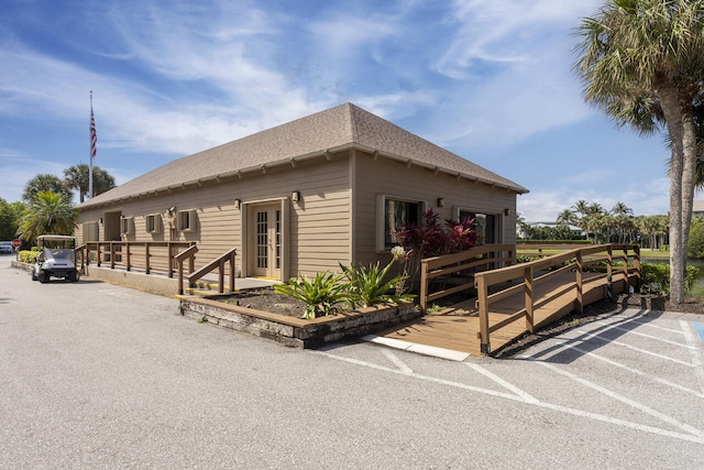 2641 NE Ocean Blvd Unit 106, Stuart, FL 34996 - view of side of home featuring a shingled roof