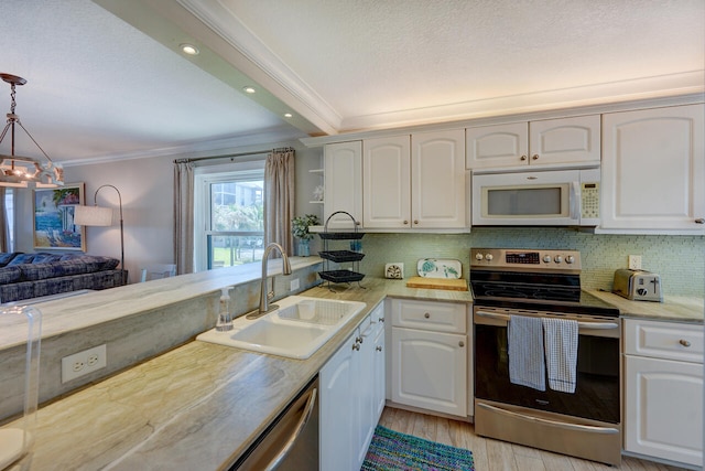 2641 NE Ocean Blvd Unit 106, Stuart, FL 34996 - kitchen featuring stainless steel electric range oven, white microwave, a sink, ornamental molding, and white cabinets