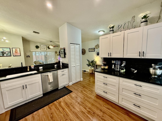 8421 SW 41st Ct, Davie, FL 33328 - kitchen featuring stainless steel dishwasher, ceiling fan, white cabinets, light wood finished floors, and dark countertops