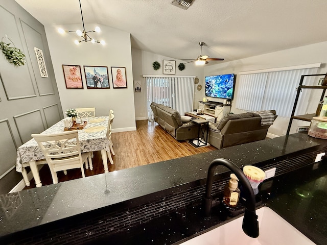 8421 SW 41st Ct, Davie, FL 33328 - dining room featuring lofted ceiling, wood finished floors, a ceiling fan, baseboards, and a chandelier