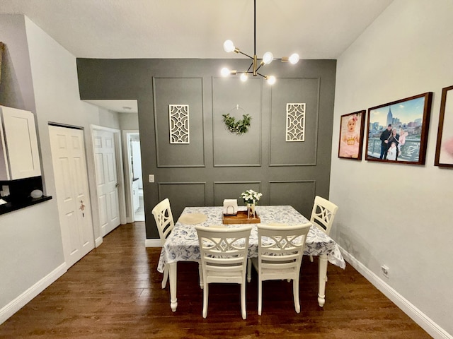 8421 SW 41st Ct, Davie, FL 33328 - dining room featuring dark wood-style floors, a chandelier, baseboards, and a decorative wall