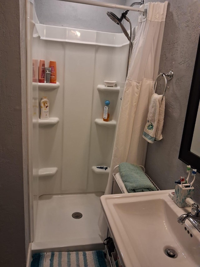 2506 Oleander Blvd, Fort Pierce, FL 34982 - full bathroom with a sink, a stall shower, and a textured wall