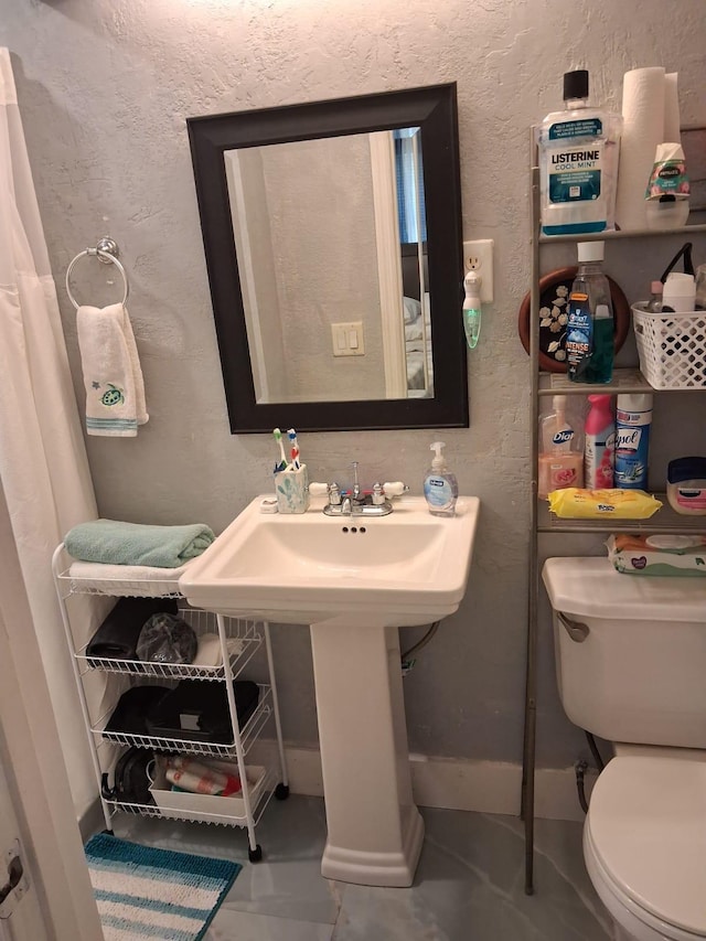 2506 Oleander Blvd, Fort Pierce, FL 34982 - bathroom with toilet, baseboards, and a textured wall