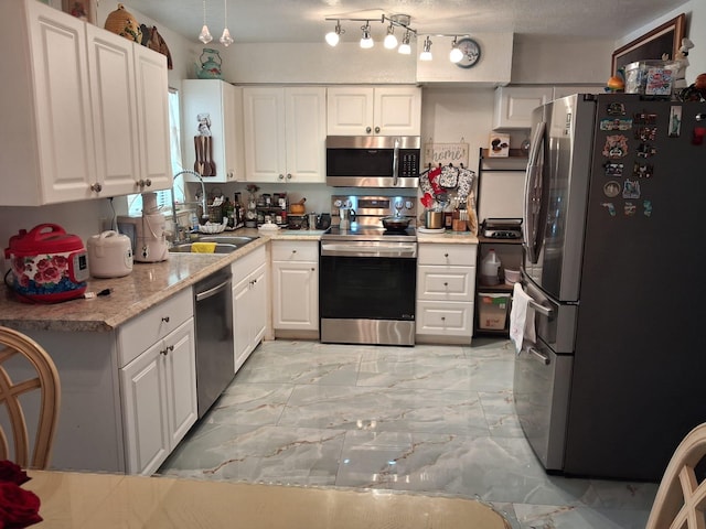 2506 Oleander Blvd, Fort Pierce, FL 34982 - kitchen with stainless steel appliances, a sink, light marble finish flooring, and white cabinetry