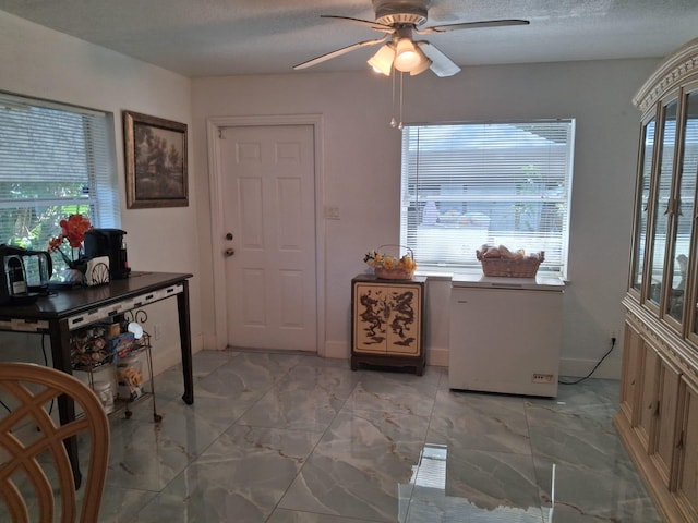 2506 Oleander Blvd, Fort Pierce, FL 34982 - foyer featuring ceiling fan, light marble finish floors, and a textured ceiling