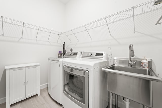 19404 Broad Shore Walk, Loxahatchee, FL 33470 - laundry room featuring washing machine and clothes dryer, a sink, and baseboards
