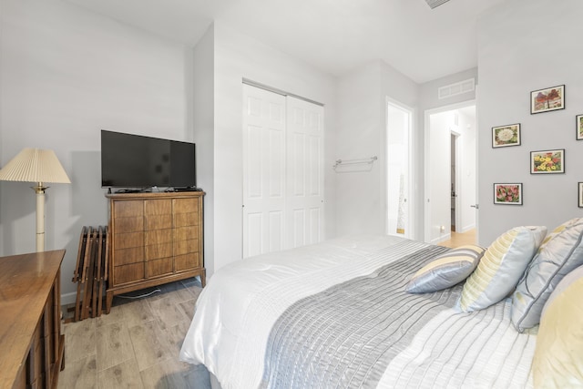 19404 Broad Shore Walk, Loxahatchee, FL 33470 - bedroom with wood finish floors, a closet, and baseboards
