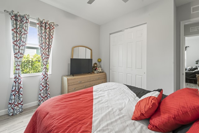 19404 Broad Shore Walk, Loxahatchee, FL 33470 - bedroom featuring light wood-style flooring, baseboards, a closet, and ceiling fan