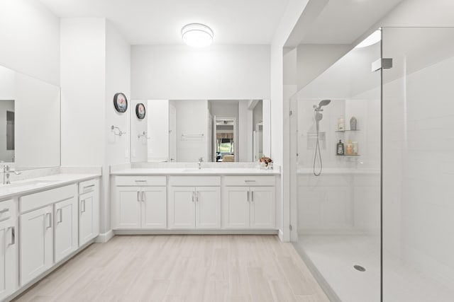 19404 Broad Shore Walk, Loxahatchee, FL 33470 - bathroom featuring a walk in shower, two vanities, and wood finished floors