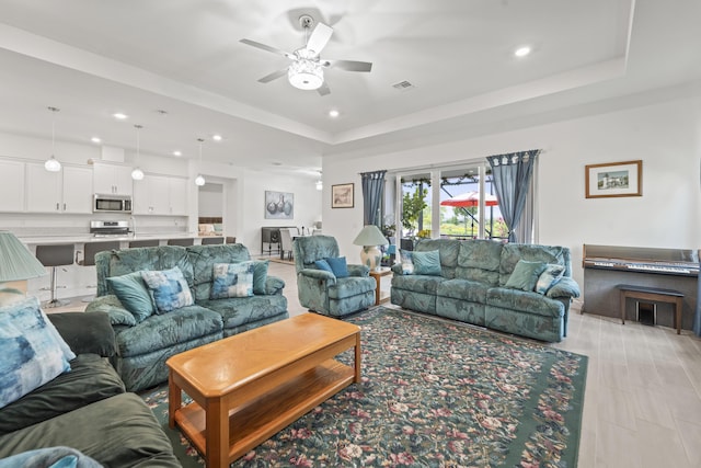 19404 Broad Shore Walk, Loxahatchee, FL 33470 - living area featuring a ceiling fan, a tray ceiling, and recessed lighting