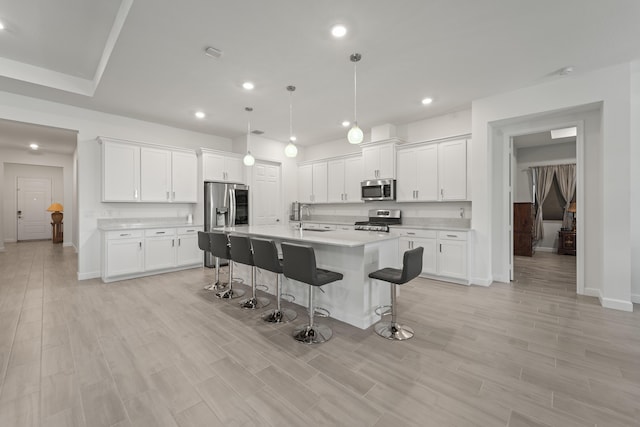 19404 Broad Shore Walk, Loxahatchee, FL 33470 - kitchen with stainless steel appliances, a kitchen breakfast bar, light countertops, baseboards, and a sink