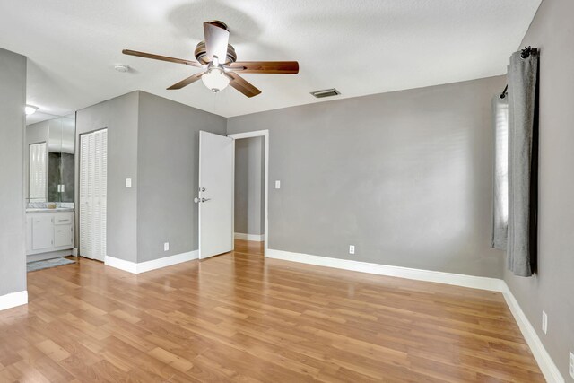 9062 NW 20th Mnr, Coral Springs, FL 33071 - unfurnished bedroom featuring light wood-type flooring, baseboards, a ceiling fan, and ensuite bath