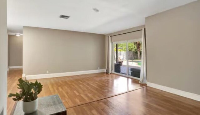 9062 NW 20th Mnr, Coral Springs, FL 33071 - empty room featuring wood finished floors and baseboards