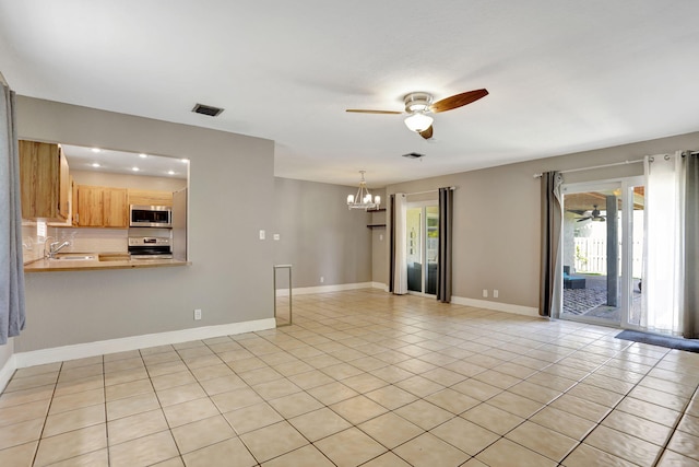 9062 NW 20th Mnr, Coral Springs, FL 33071 - unfurnished living room featuring a ceiling fan, a chandelier, a sink, light tile patterned floors, and baseboards