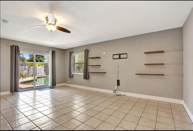 9062 NW 20th Mnr, Coral Springs, FL 33071 - unfurnished room with a ceiling fan, light tile patterned floors, a smoke detector, and baseboards