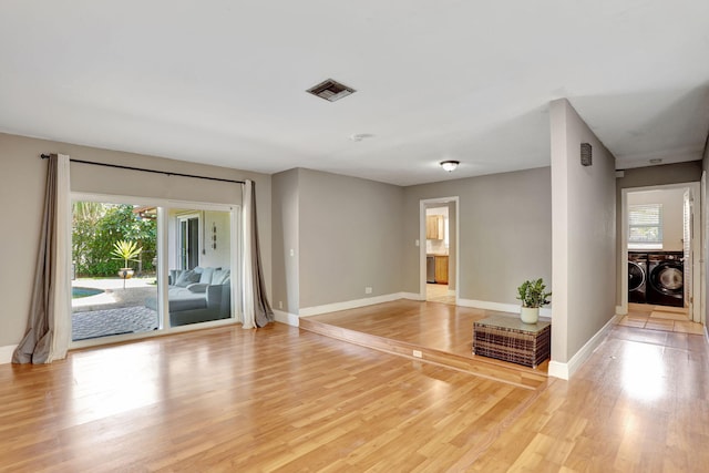 9062 NW 20th Mnr, Coral Springs, FL 33071 - unfurnished room featuring washer and clothes dryer, baseboards, and light wood finished floors