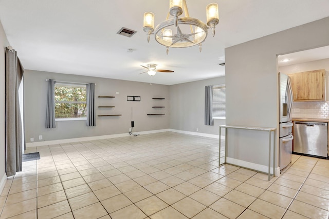 9062 NW 20th Mnr, Coral Springs, FL 33071 - empty room with a chandelier, light tile patterned floors, ceiling fan, and baseboards