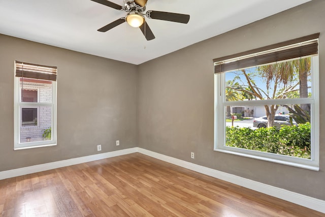 9062 NW 20th Mnr, Coral Springs, FL 33071 - spare room with wood finished floors, baseboards, and a ceiling fan