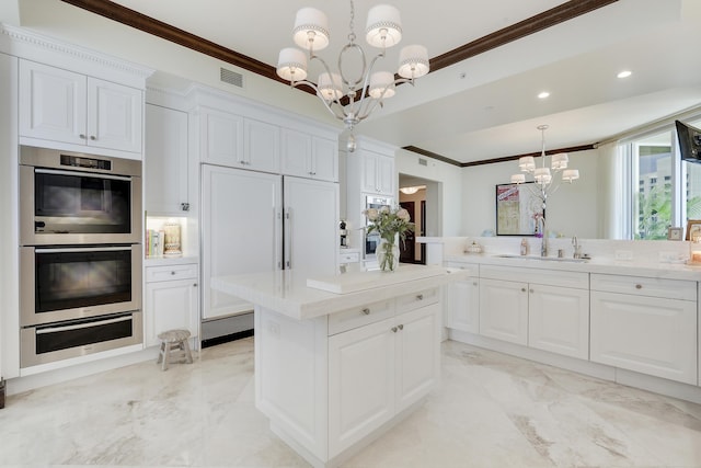 5050 N Ocean Dr Unit 1701, Singer Island, FL 33404 - kitchen with a chandelier, double oven, a sink, a warming drawer, and crown molding