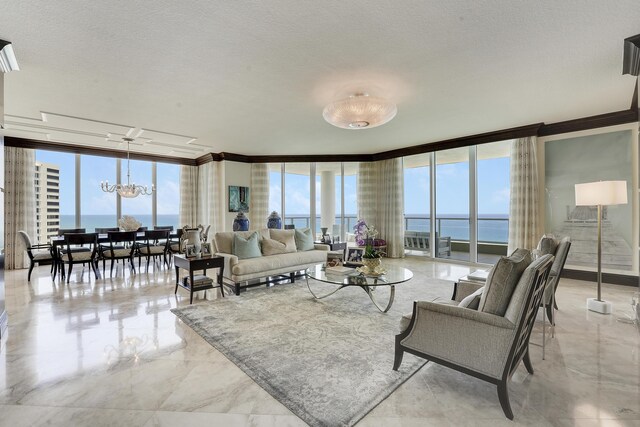 5050 N Ocean Dr Unit 1701, Singer Island, FL 33404 - living room with ornamental molding, a wall of windows, a chandelier, healthy amount of natural light, and a water view