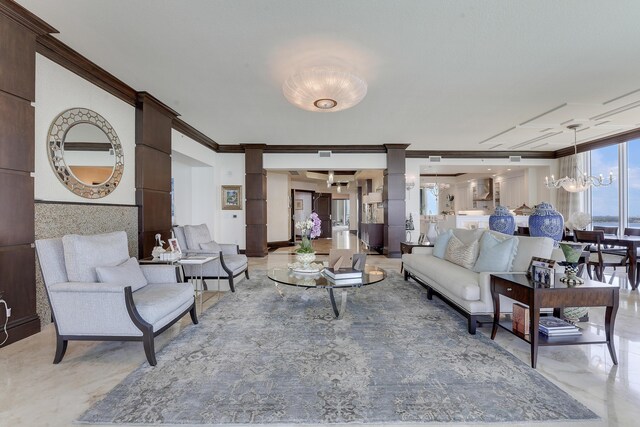5050 N Ocean Dr Unit 1701, Singer Island, FL 33404 - living room with decorative columns, ornamental molding, and a chandelier