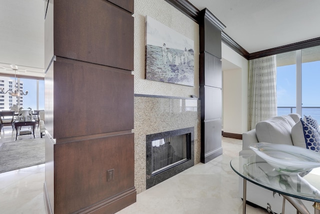 5050 N Ocean Dr Unit 1701, Singer Island, FL 33404 - living area featuring floor to ceiling windows, a multi sided fireplace, a chandelier, and ornamental molding