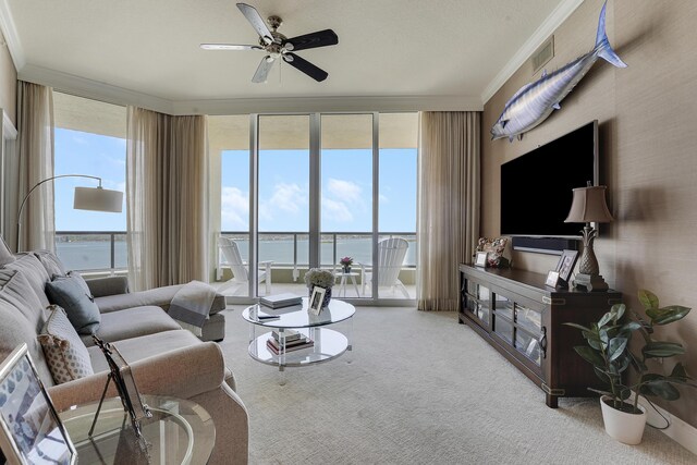 5050 N Ocean Dr Unit 1701, Singer Island, FL 33404 - carpeted living room featuring crown molding, ceiling fan, and a wall of windows