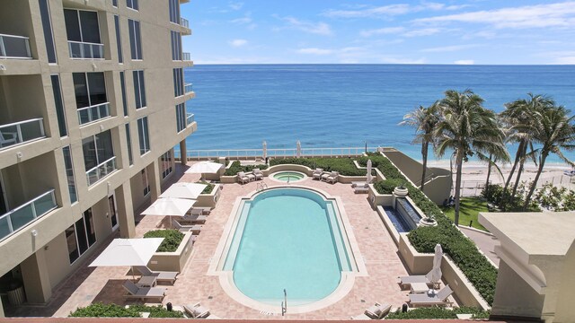 5050 N Ocean Dr Unit 1701, Singer Island, FL 33404 - community pool with a water view, a hot tub, and a patio