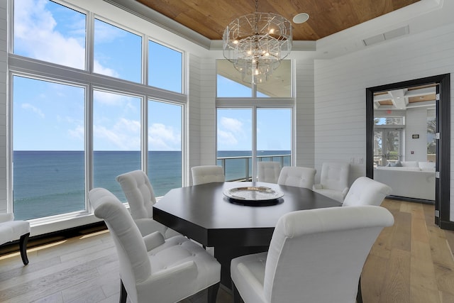 5050 N Ocean Dr Unit 1701, Singer Island, FL 33404 - dining space with wooden ceiling, a towering ceiling, light wood-type flooring, a chandelier, and a water view