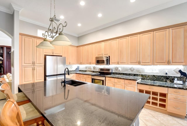 8127 Playa Del Sur Blvd, Lake Worth, FL 33467 - kitchen with appliances with stainless steel finishes, a sink, arched walkways, light brown cabinetry, and dark stone counters