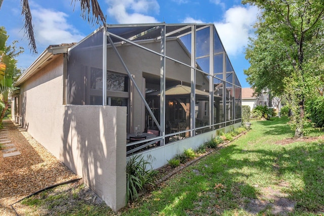 8127 Playa Del Sur Blvd, Lake Worth, FL 33467 - rear view of house with a lanai, stucco siding, and a yard