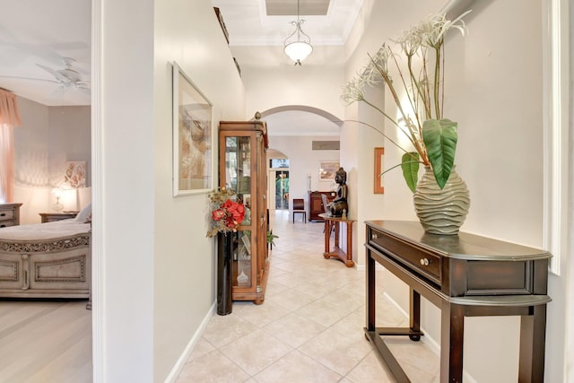 8127 Playa Del Sur Blvd, Lake Worth, FL 33467 - hallway with arched walkways, crown molding, baseboards, and light tile patterned flooring