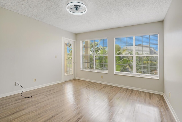 6315 La Costa Dr Unit G, Boca Raton, FL 33433 - empty room featuring a textured ceiling, wood finished floors, and baseboards