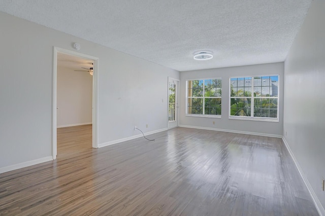 6315 La Costa Dr Unit G, Boca Raton, FL 33433 - empty room with wood finished floors, a textured ceiling, baseboards, and a ceiling fan