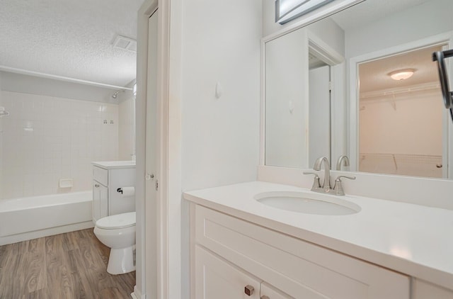 6315 La Costa Dr Unit G, Boca Raton, FL 33433 - bathroom with vanity, wood finished floors, toilet, shower / bath combination, and a textured ceiling
