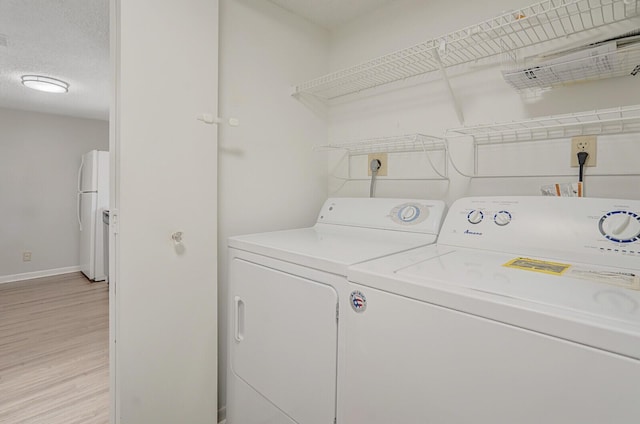 6315 La Costa Dr Unit G, Boca Raton, FL 33433 - laundry area featuring washing machine and dryer, light wood finished floors, and baseboards